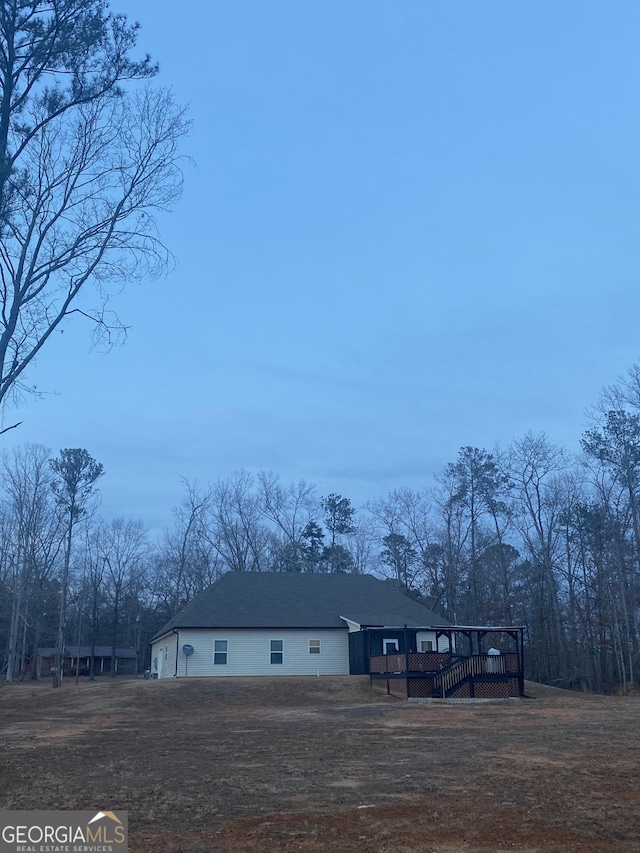 view of front facade featuring a garage and a deck