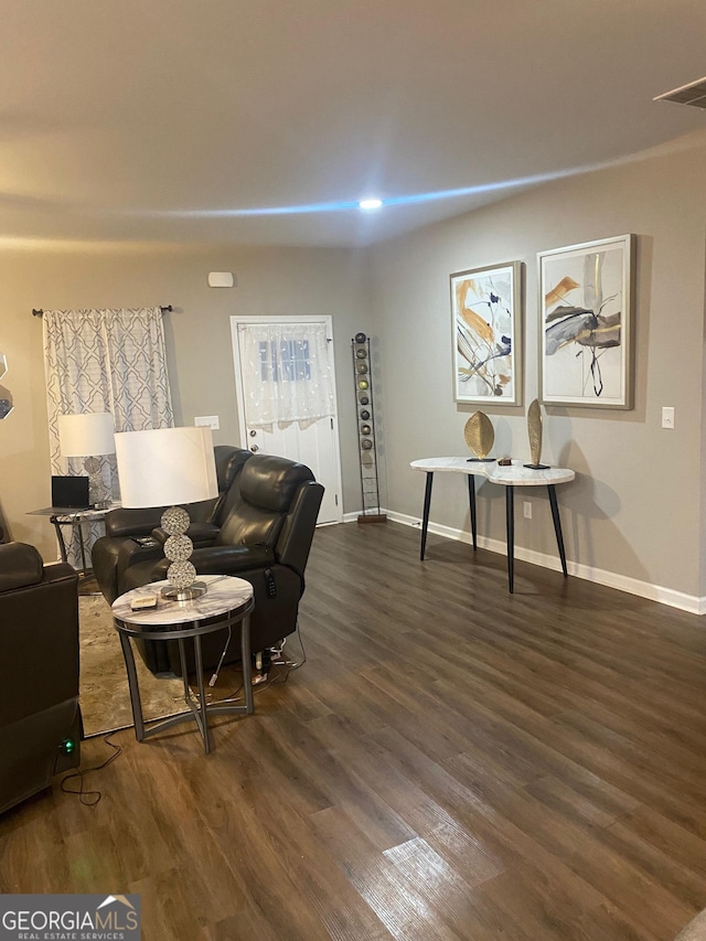 living room with dark hardwood / wood-style flooring