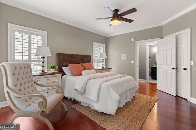 bedroom with dark wood-type flooring, ornamental molding, and ceiling fan