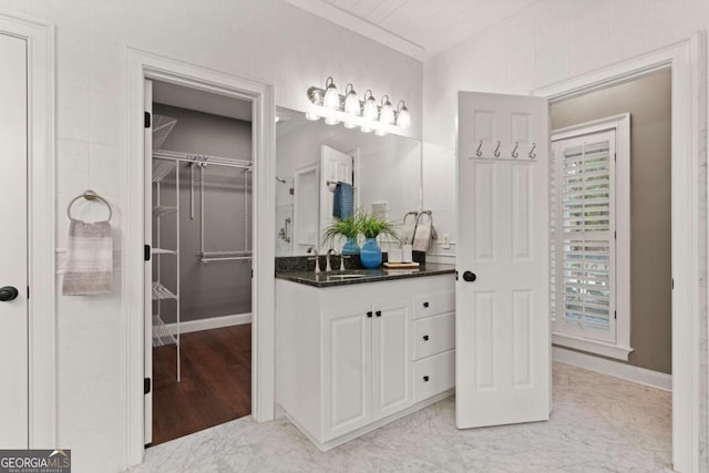 bathroom featuring vanity and lofted ceiling