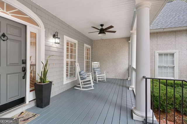 wooden terrace with a porch and ceiling fan