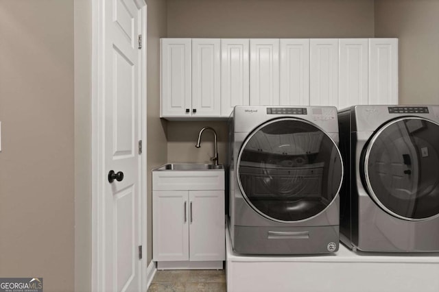 laundry area with sink, cabinets, and independent washer and dryer