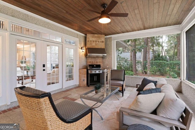 sunroom with french doors, ceiling fan, and wooden ceiling