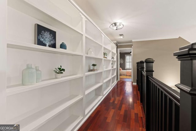 hallway with ornamental molding and dark wood-type flooring