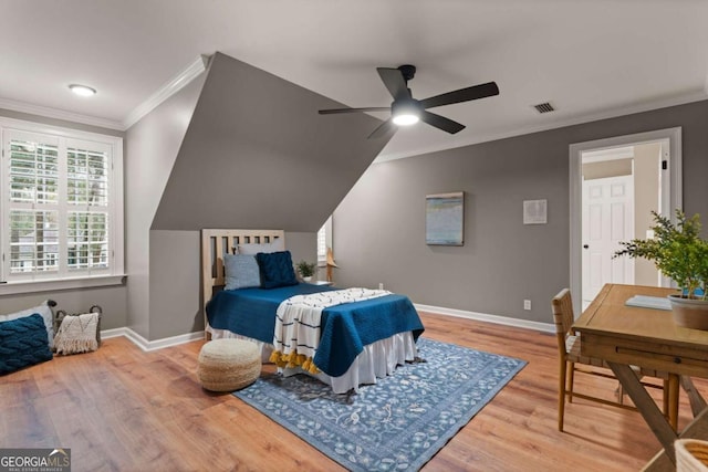 bedroom featuring wood-type flooring, ornamental molding, and ceiling fan