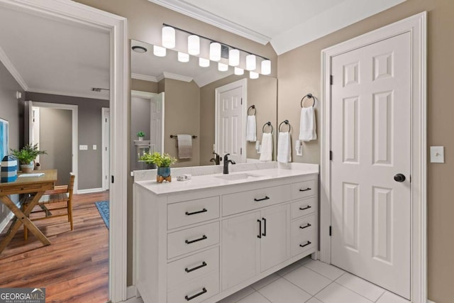 bathroom with vanity, crown molding, and wood-type flooring