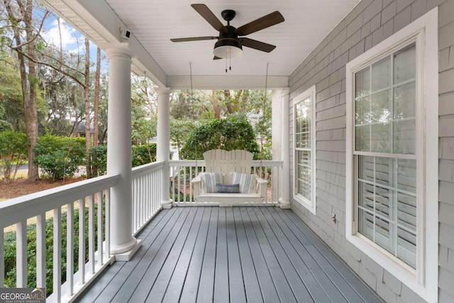 wooden terrace featuring a porch and ceiling fan