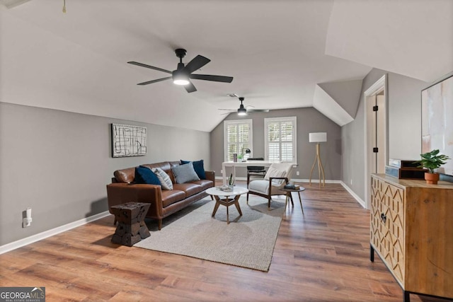 living room with lofted ceiling, hardwood / wood-style floors, and ceiling fan