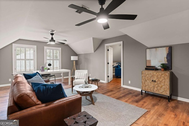 living room with ceiling fan, lofted ceiling, and hardwood / wood-style floors