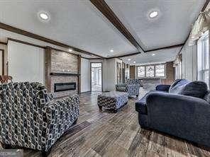 living room with beam ceiling and hardwood / wood-style flooring