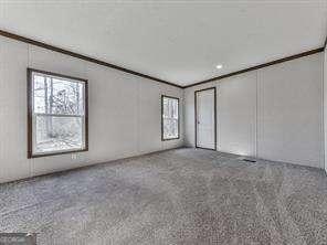 spare room featuring crown molding