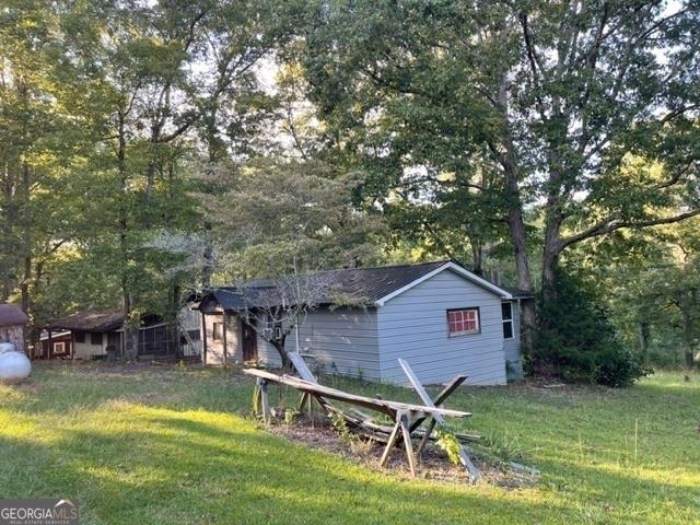 view of outbuilding with a yard