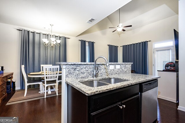 kitchen with pendant lighting, sink, dishwasher, a kitchen island with sink, and vaulted ceiling