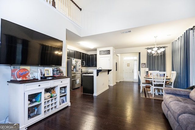 kitchen featuring visible vents, appliances with stainless steel finishes, open floor plan, and dark wood finished floors