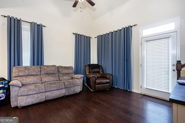 living area featuring vaulted ceiling, ceiling fan, wood finished floors, and a healthy amount of sunlight