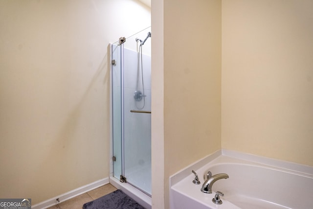 bathroom with independent shower and bath and tile patterned floors