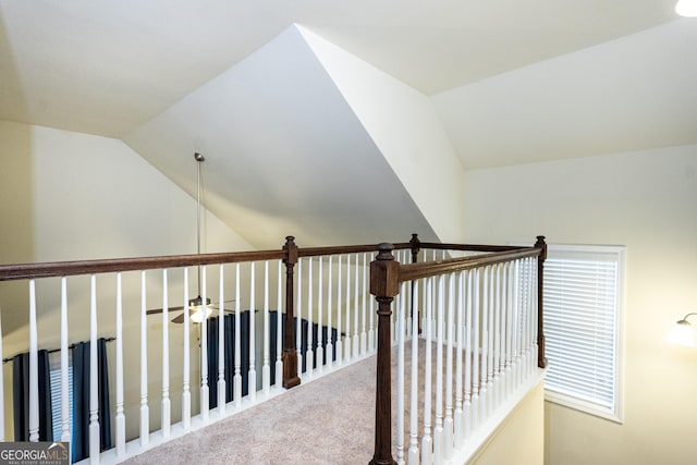 hallway with lofted ceiling and carpet