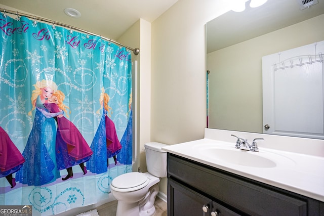 bathroom featuring vanity, tile patterned flooring, curtained shower, and toilet