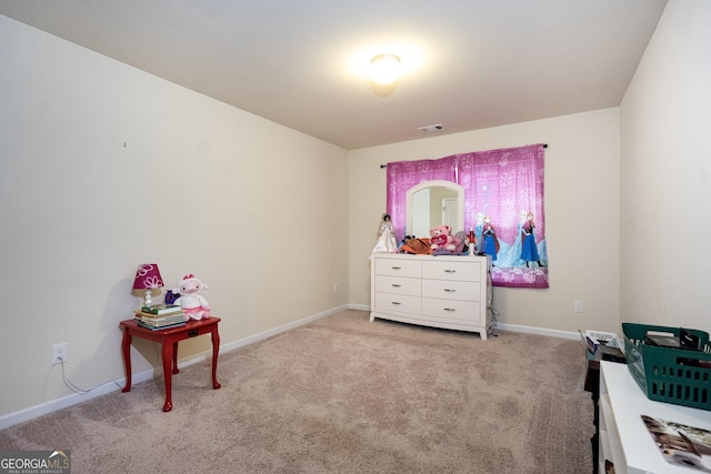 interior space with light carpet, visible vents, and baseboards