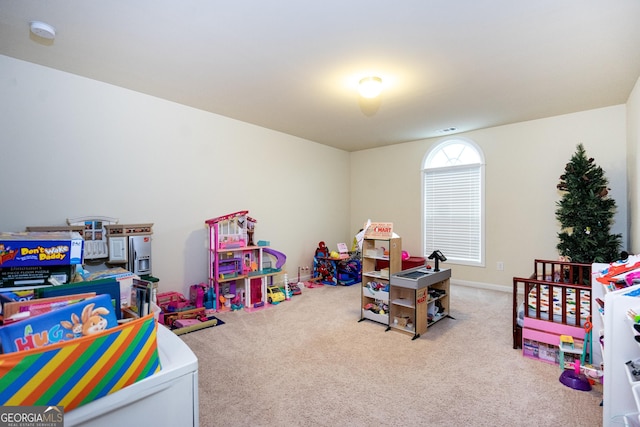 rec room with carpet, visible vents, and baseboards