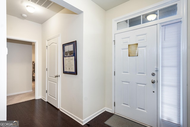 foyer featuring dark wood-style floors, visible vents, and baseboards