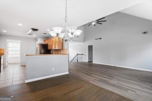 kitchen featuring stainless steel refrigerator, sink, dark wood-type flooring, and tasteful backsplash