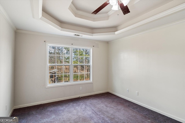 carpeted spare room featuring a raised ceiling, crown molding, and ceiling fan