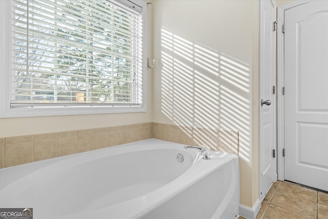 bathroom with a bath and tile patterned floors