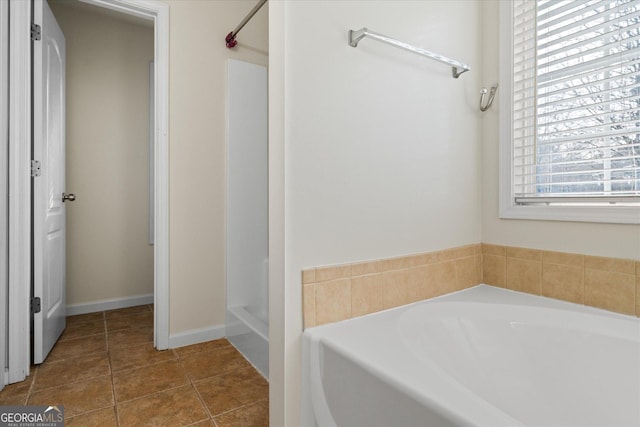 bathroom featuring a washtub and tile patterned floors