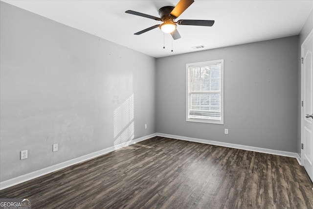 empty room featuring dark hardwood / wood-style floors and ceiling fan