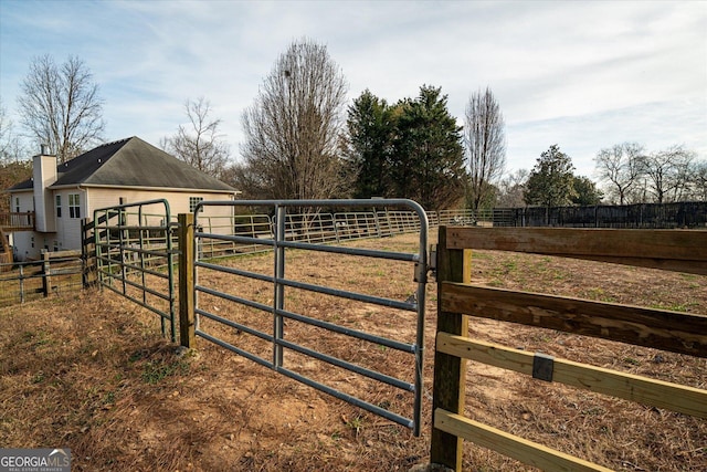 view of gate with a rural view