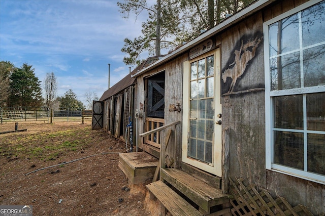 view of side of home featuring an outdoor structure