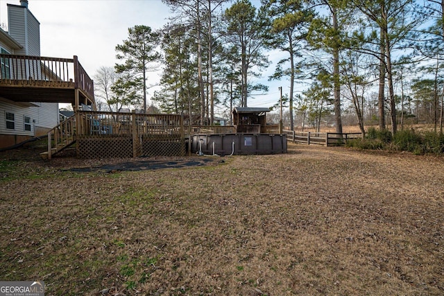 view of yard with a pool side deck