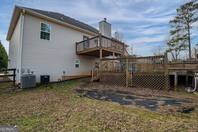 back of house with cooling unit and a deck