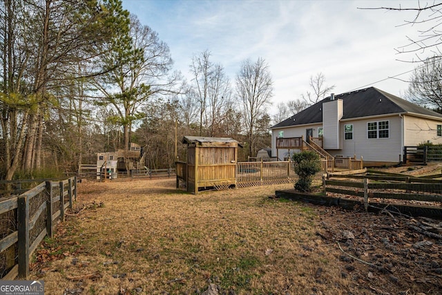 view of yard featuring an outbuilding and a swimming pool side deck