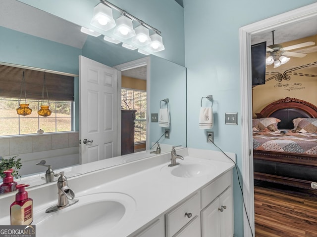 bathroom with vanity, hardwood / wood-style floors, a wealth of natural light, and ceiling fan