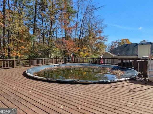 view of swimming pool featuring a deck