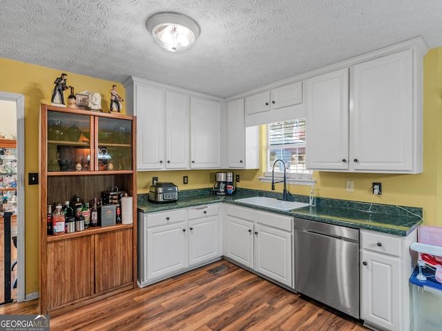 kitchen featuring dishwasher, sink, dark wood-type flooring, and white cabinets