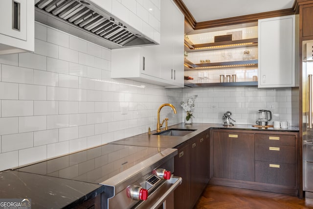 kitchen featuring white cabinetry, sink, dark parquet flooring, dark brown cabinets, and wall chimney range hood