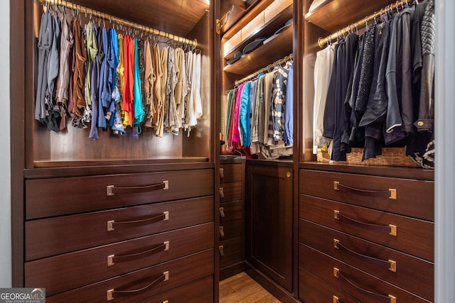 spacious closet with light hardwood / wood-style floors