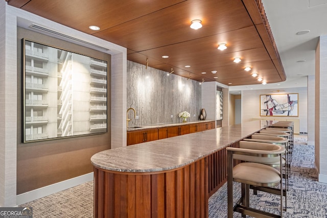 bar featuring wood ceiling and sink