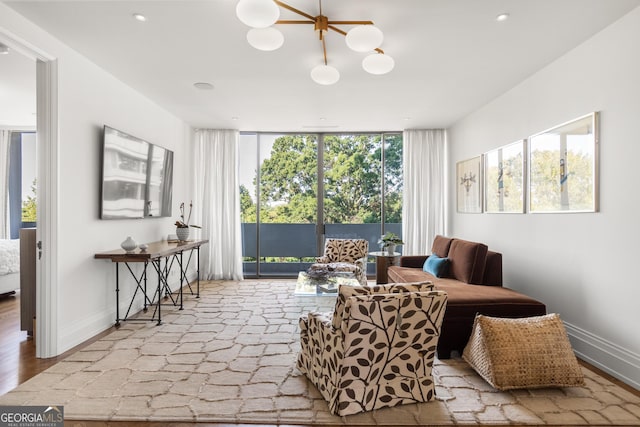 sitting room featuring floor to ceiling windows, light wood-type flooring, and a wealth of natural light