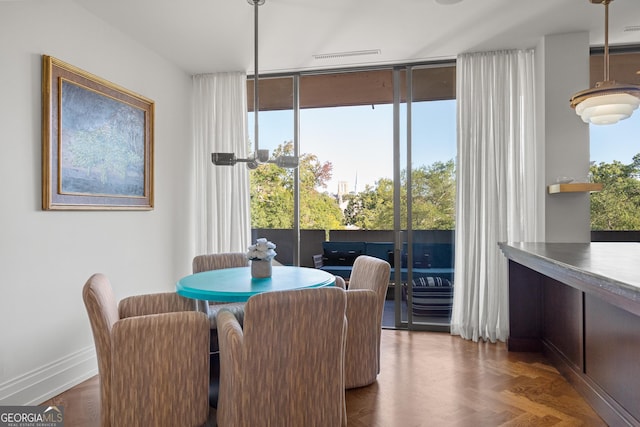 dining area featuring dark parquet floors