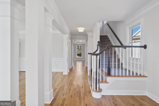 4974 Dovecote Trl, Suwanee, GA 30024 - corridor with wood finished floors, stairway, ornamental molding, wainscoting, and a decorative wall