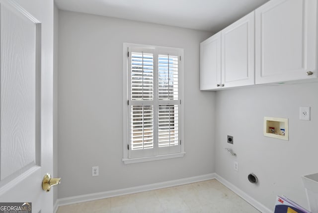 clothes washing area with cabinets, electric dryer hookup, and washer hookup