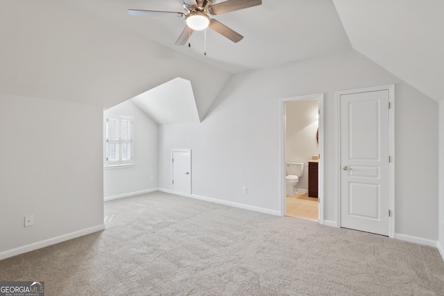 bonus room featuring ceiling fan, lofted ceiling, and light carpet