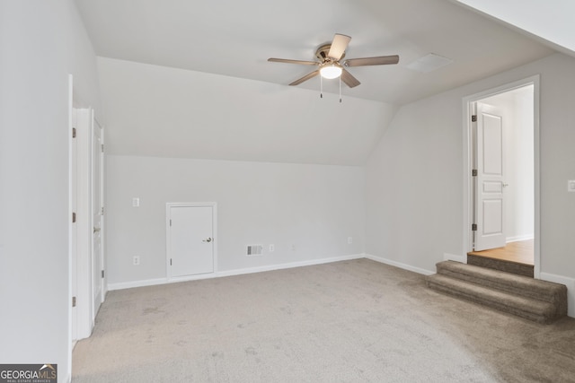 bonus room with lofted ceiling, light carpet, and ceiling fan