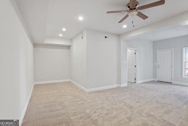 carpeted spare room featuring ceiling fan