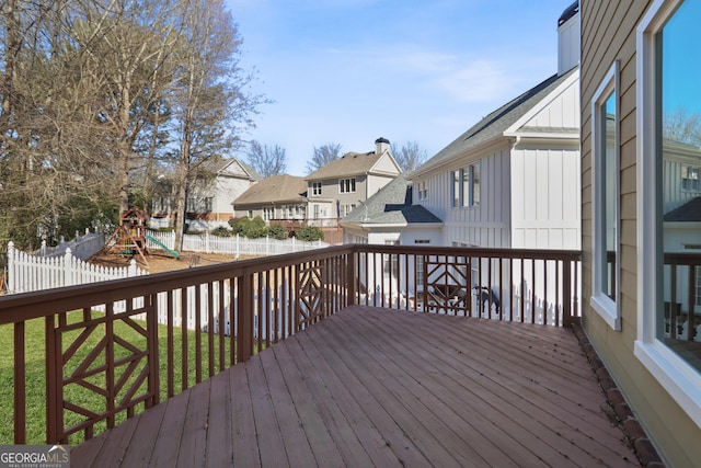 deck featuring a yard and a playground