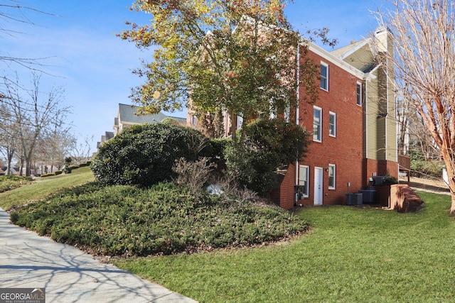 4974 Dovecote Trl, Suwanee, GA 30024 - view of property exterior with a chimney, brick siding, and a yard